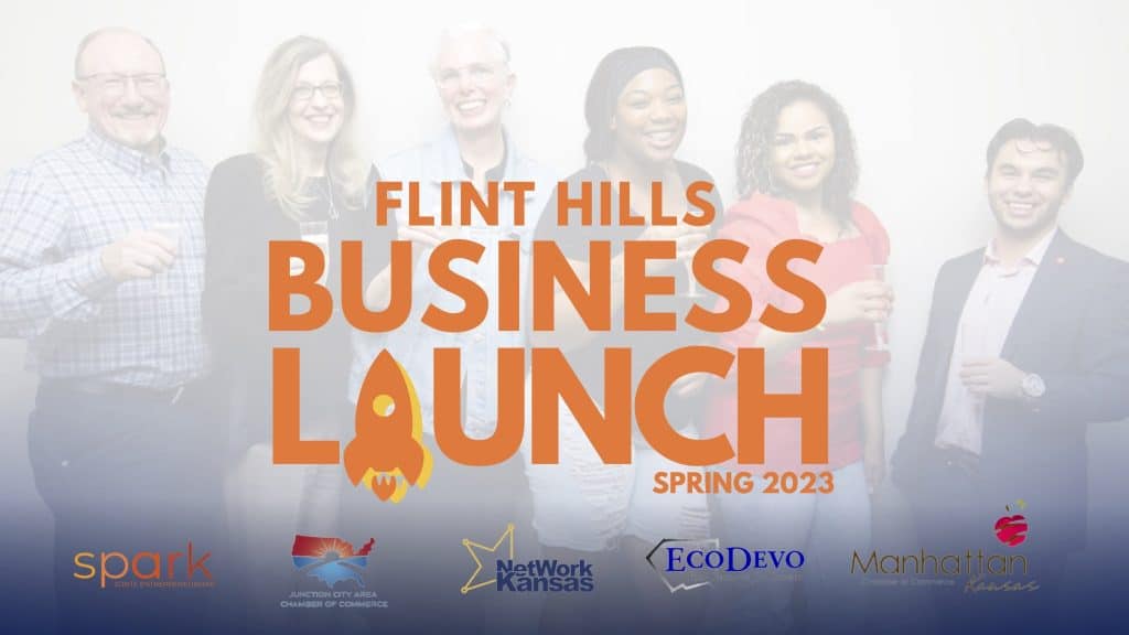 A group of six smiling people stand in a line, holding drinks and posing in front of a backdrop that reads "Flint Hills Business Launch Spring 2023." Various sponsor logos are displayed at the bottom, including Spark, Junction City Area Chamber of Commerce, Network Kansas, EcoDevo, and Manhattan.
