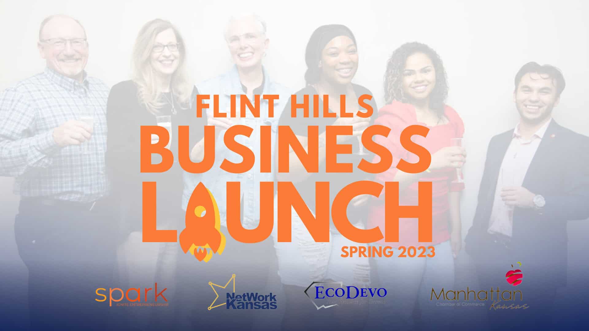 A group of six people stand together, smiling and holding drinks, in front of a backdrop that reads "Flint Hills Business Launch Spring 2023" with logos for Spark, NetWork Kansas, EcoDevo, and the Manhattan Area Chamber of Commerce at the bottom.